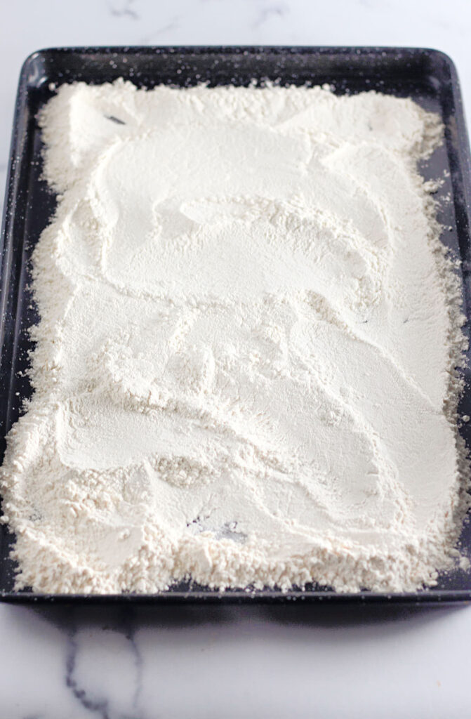 Raw flour on a baking sheet to be baked.